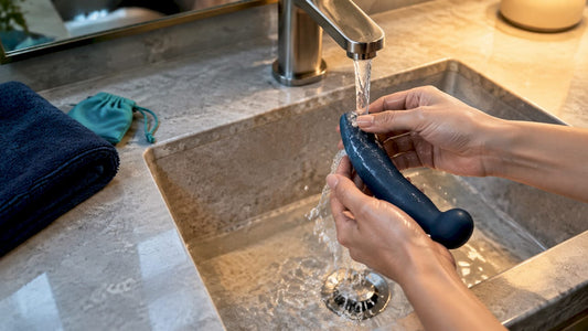 Hands rinsing an anonymous intimate device