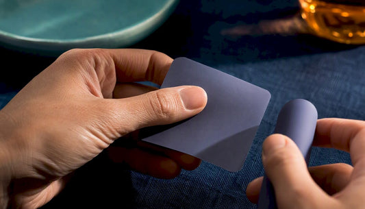 Hands examining silicone and vibrator material