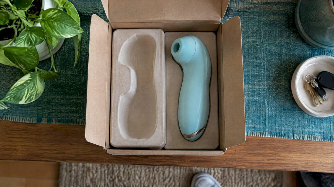 Clitoral suction toy beside discreet shipping carton